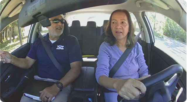 adult student practicing behind the wheel with certified instructor